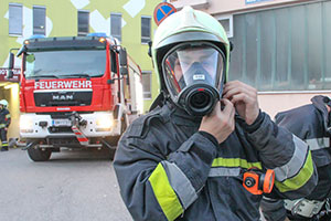 Feuerwehrmänner mit Atemschutz auf einer Drehleiter